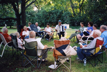 Group of people sitting and talking under a tree