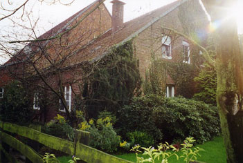 A Brick Old House With Garden Behind