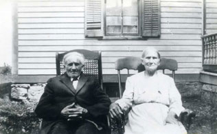 A Man and a Woman Sitting on Chairs Black and White