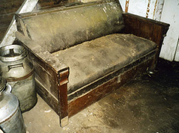 An Old Dust Covered Wooden Sofa
