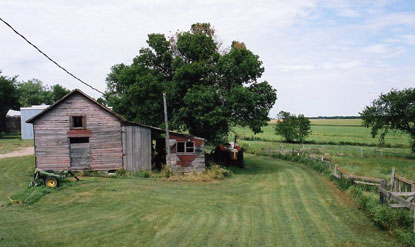A Wood Farm House Beside Green Fields